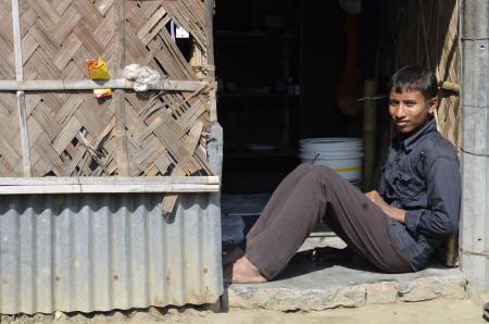 Ashraful sits in doorway of his families new home in Dhaka, Bangladesh Ashraful sits in doorway of his families new home in Dhaka, Bangladesh